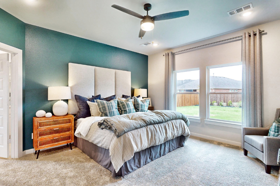 A bedroom with a large window.