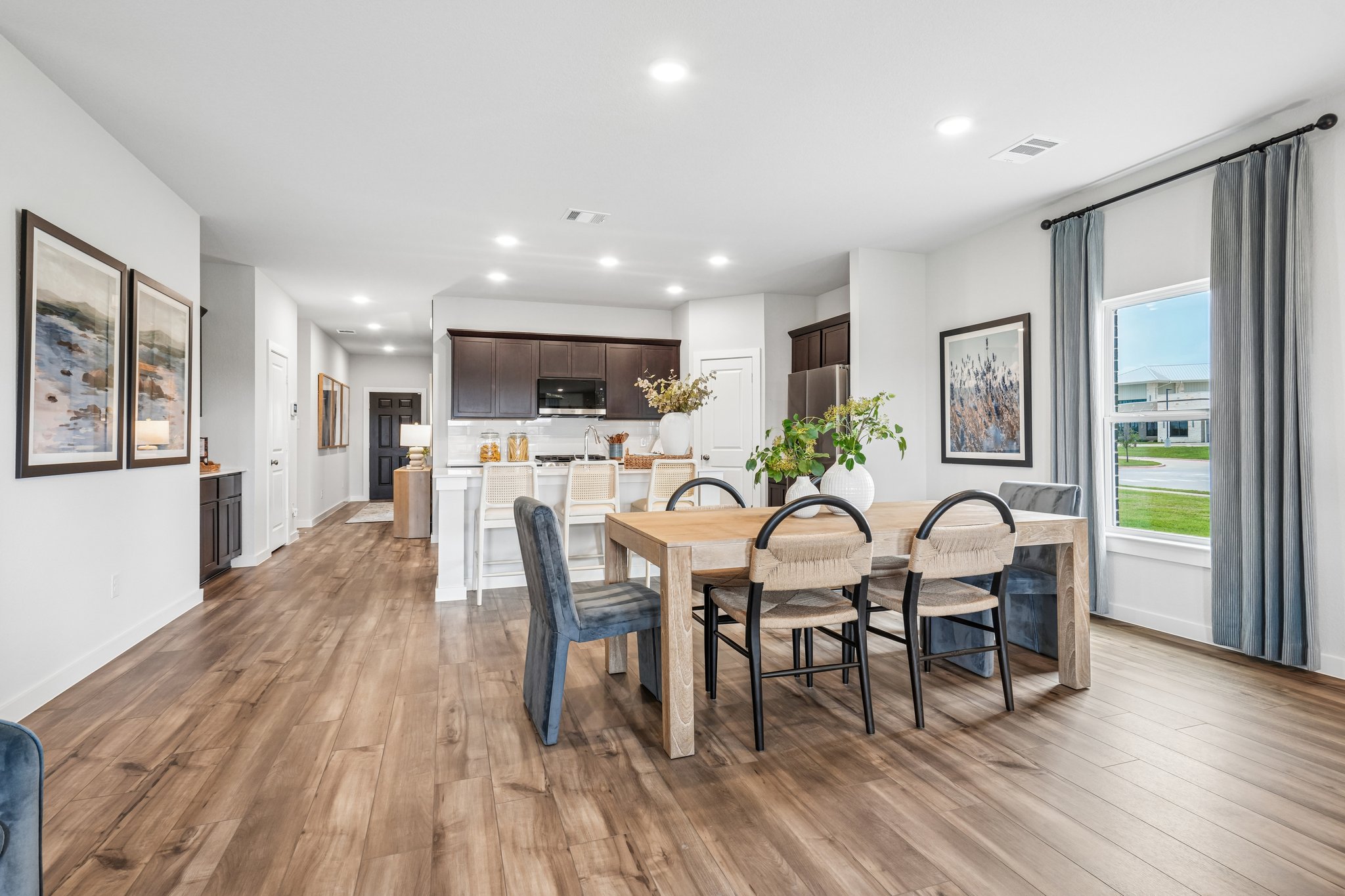 A dining room with a table and chairs.