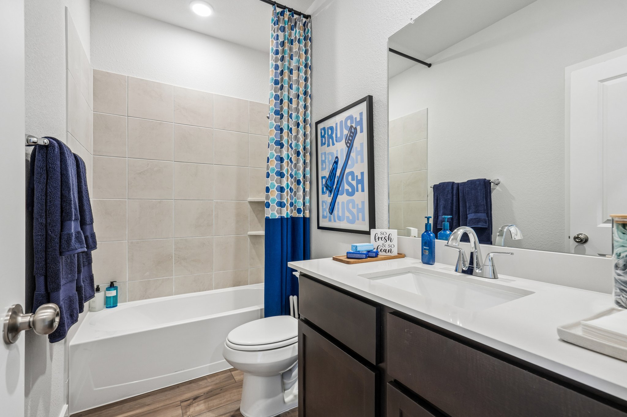 A bathroom with a tub sink and toilet.