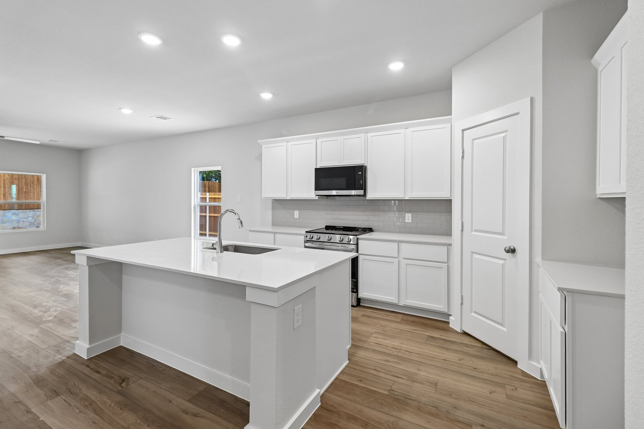 A kitchen with white cabinets.