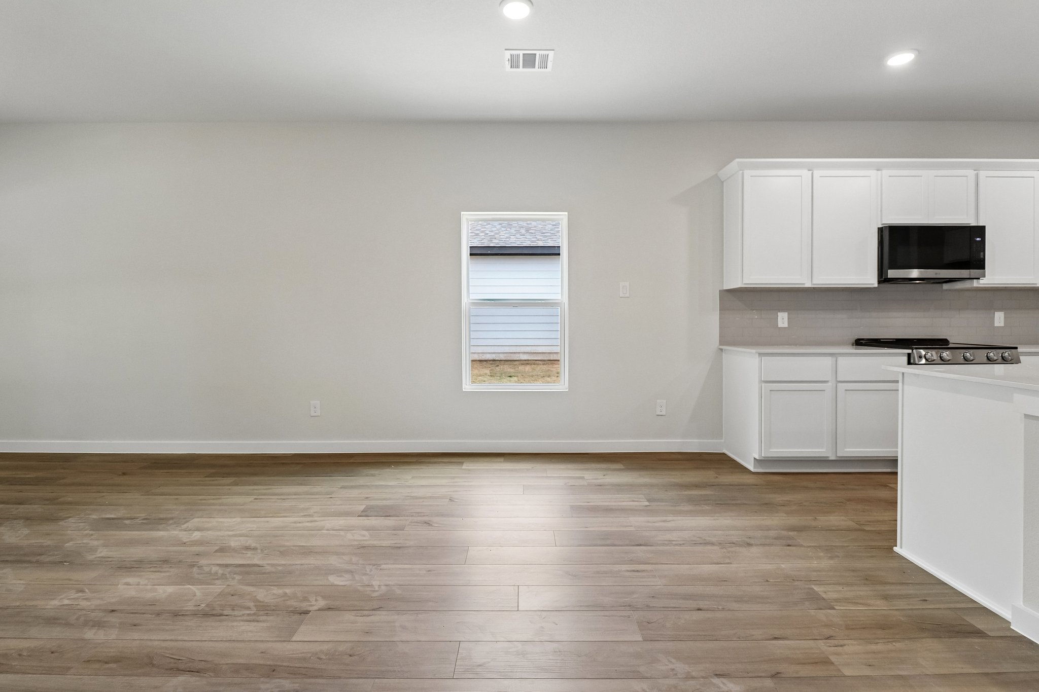 A kitchen with white cabinets.
