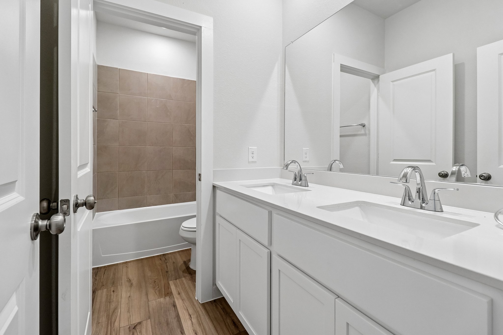 A bathroom with a tub sink and toilet.