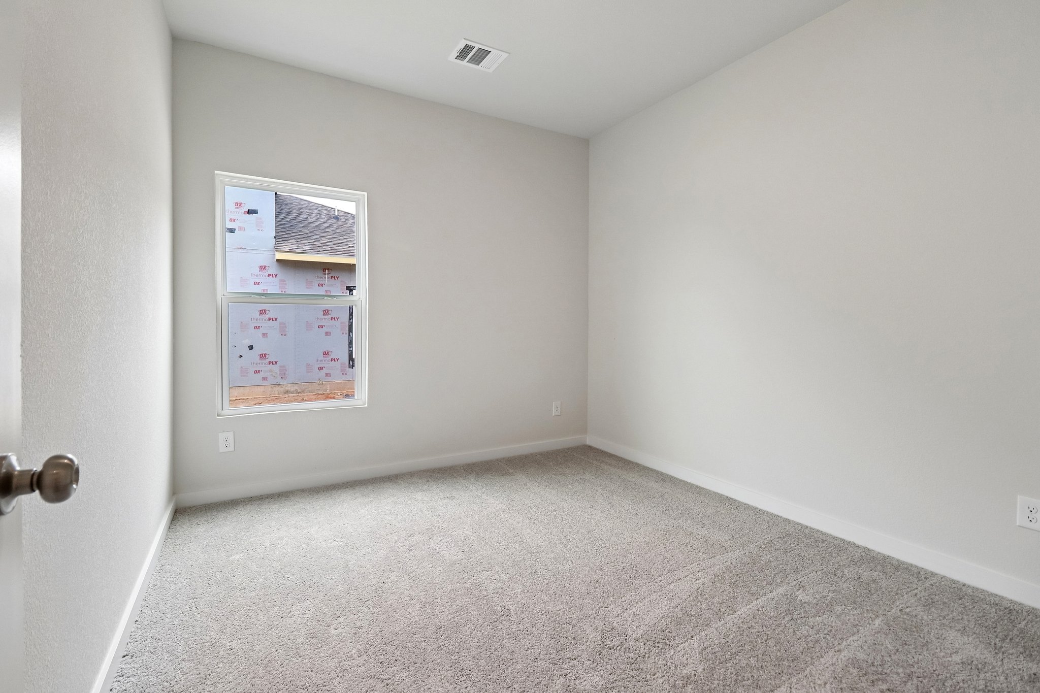 A hallway with a poster on the wall.