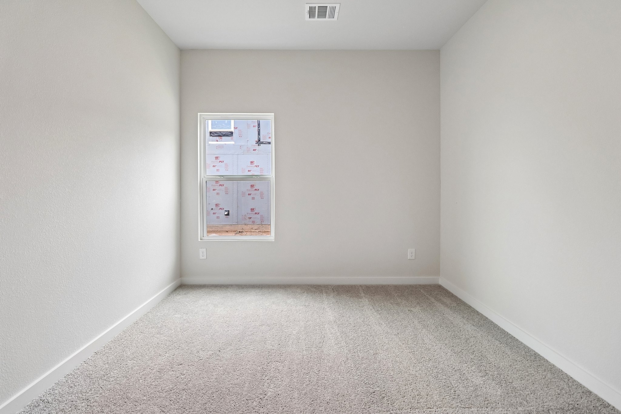A white wall with a poster on it.