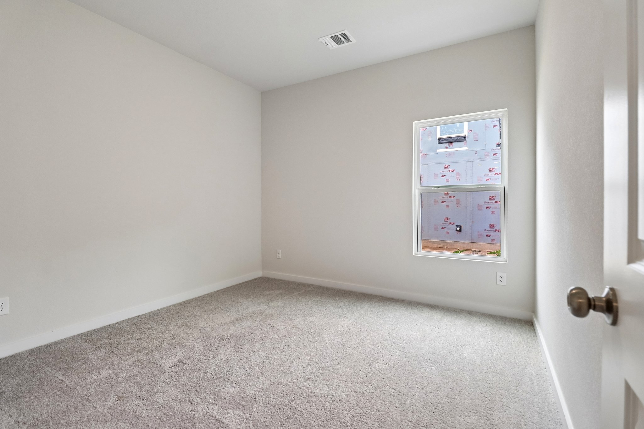 A room with a poster on the wall.