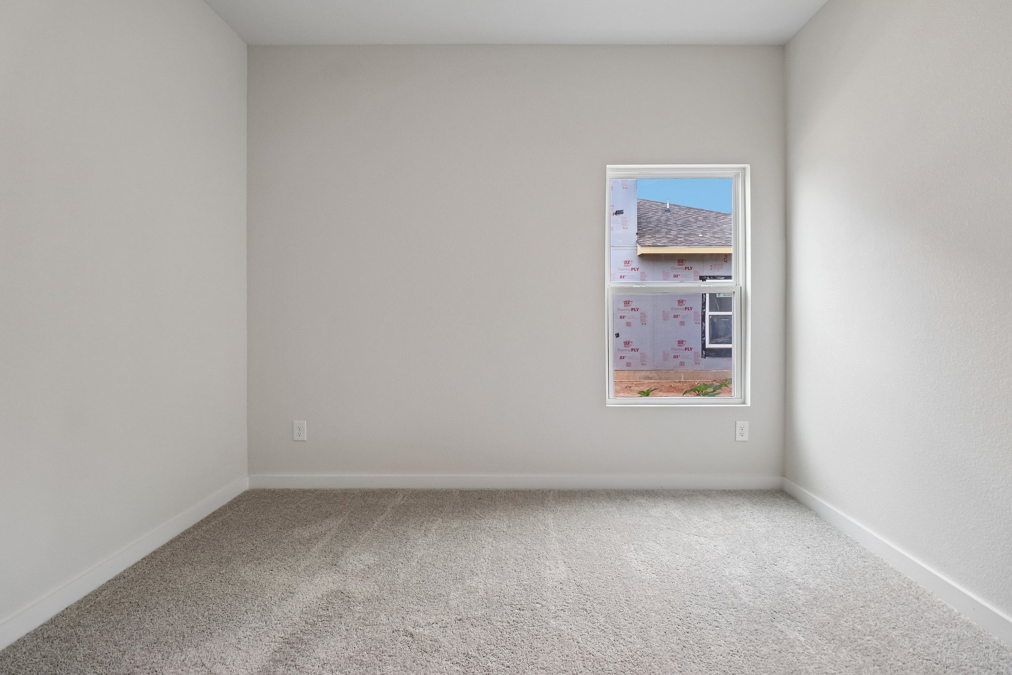 A white wall with a picture on it.