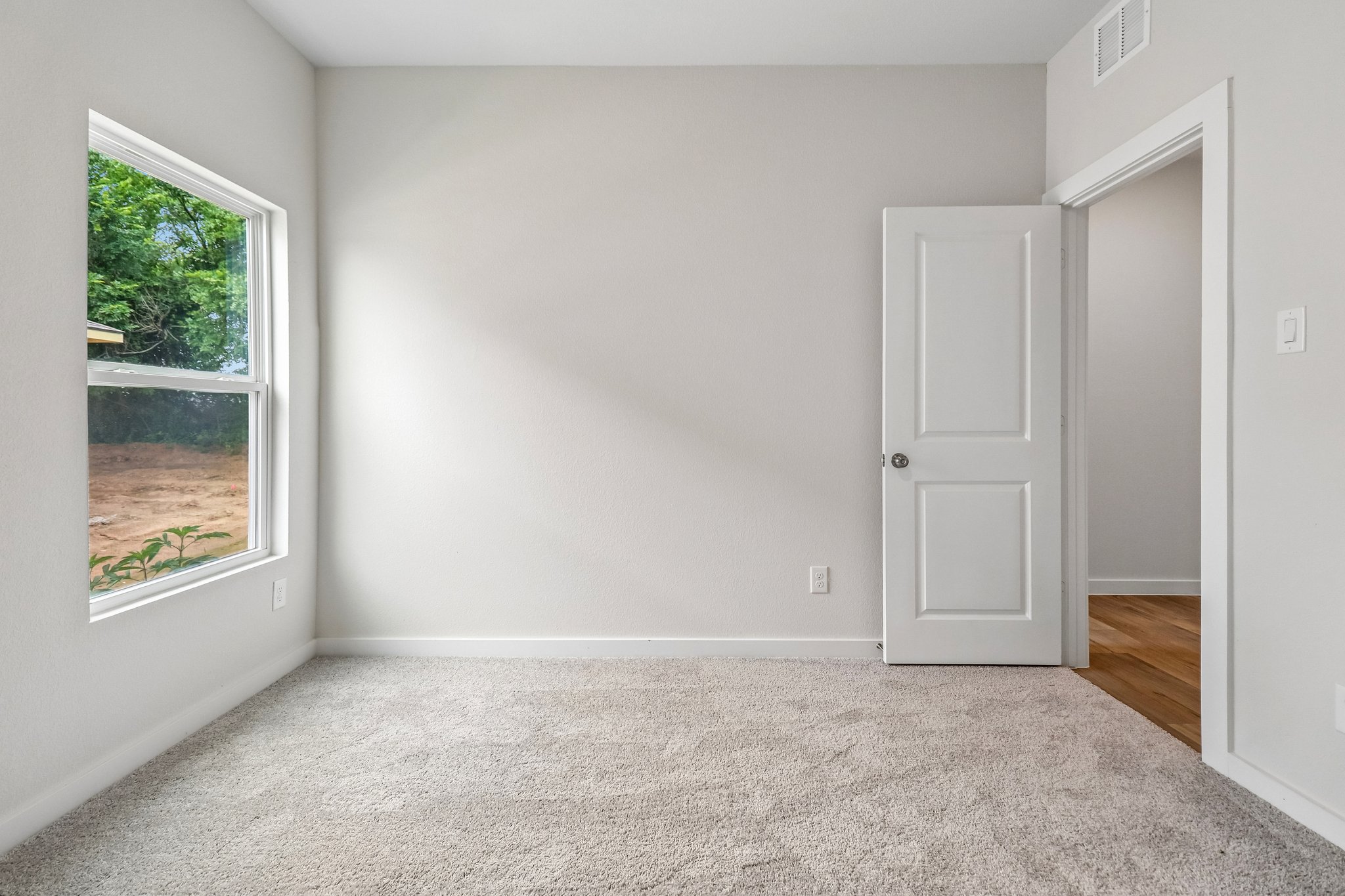 A room with a door and a window.