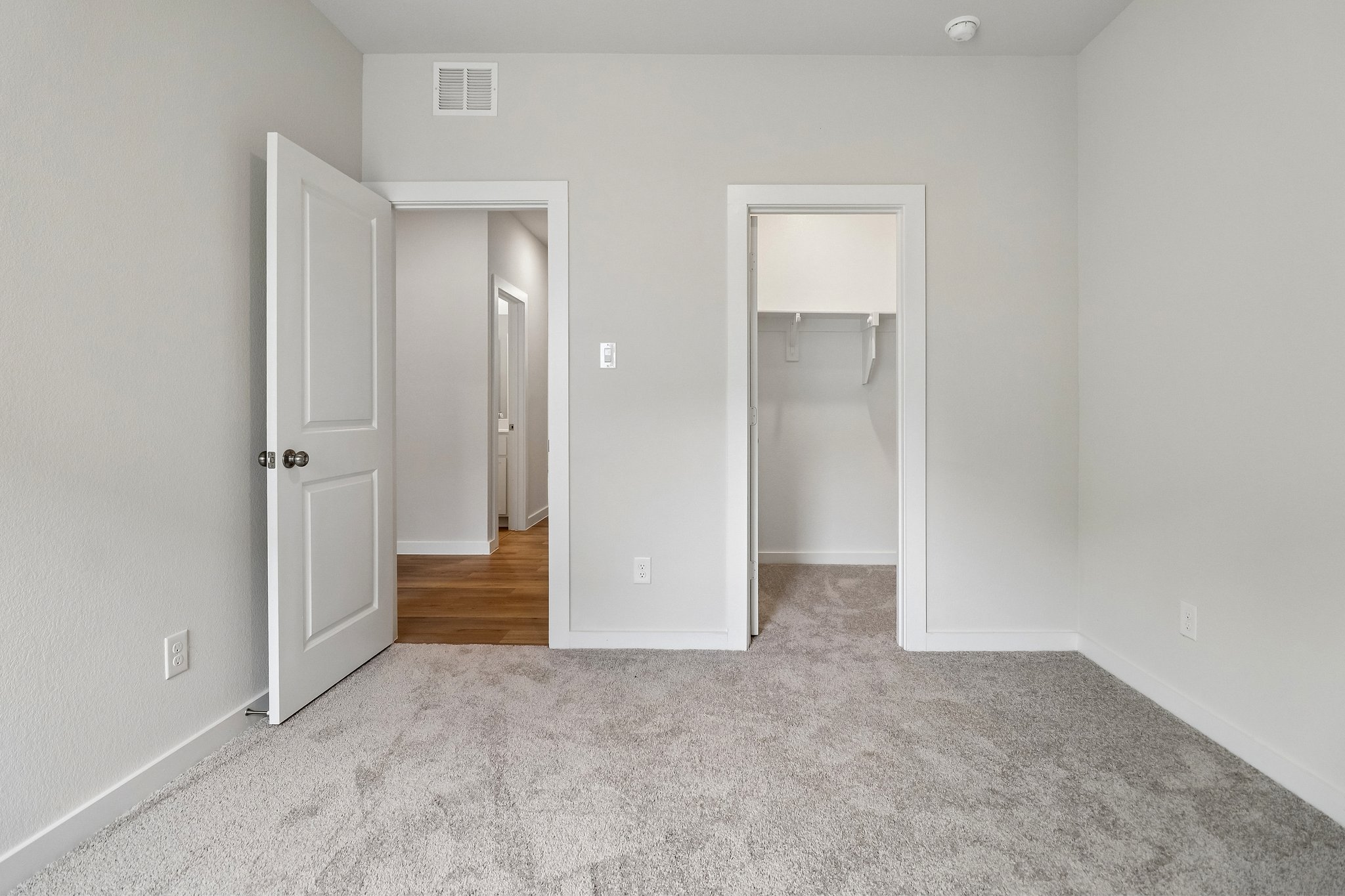 A hallway with white doors.