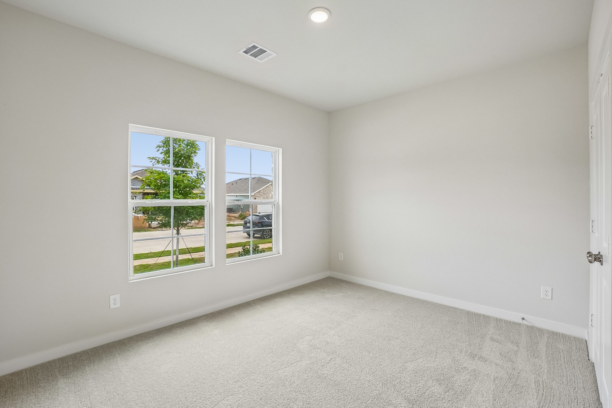 A room with a window and a door.