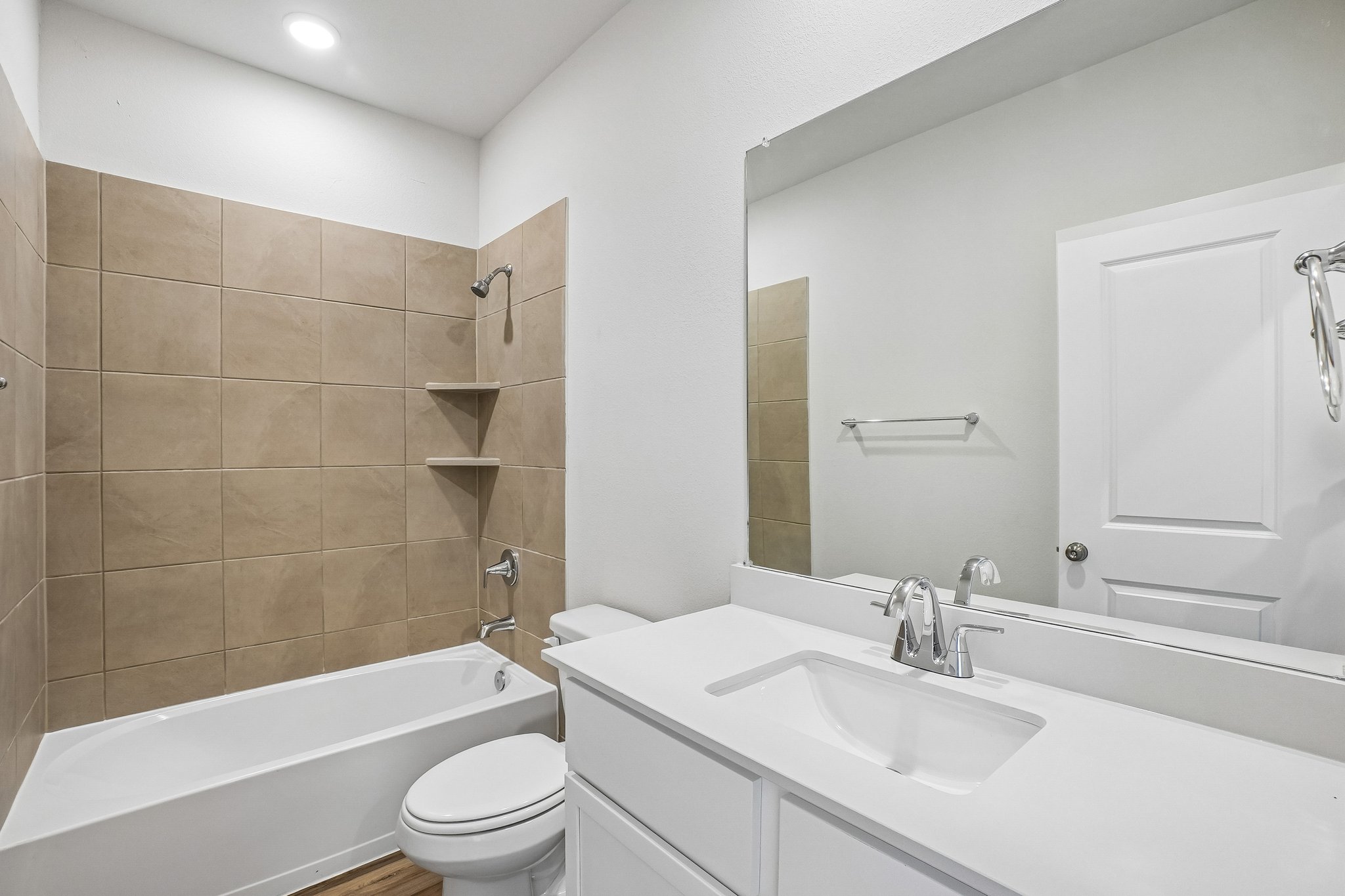 A bathroom with a tub sink and toilet.