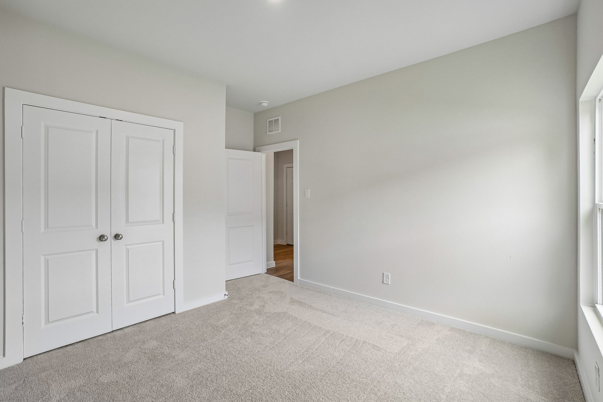A hallway with white doors.