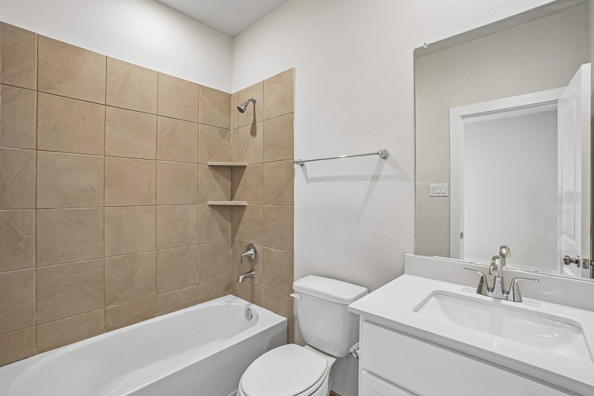 A bathroom with a tub sink and toilet.