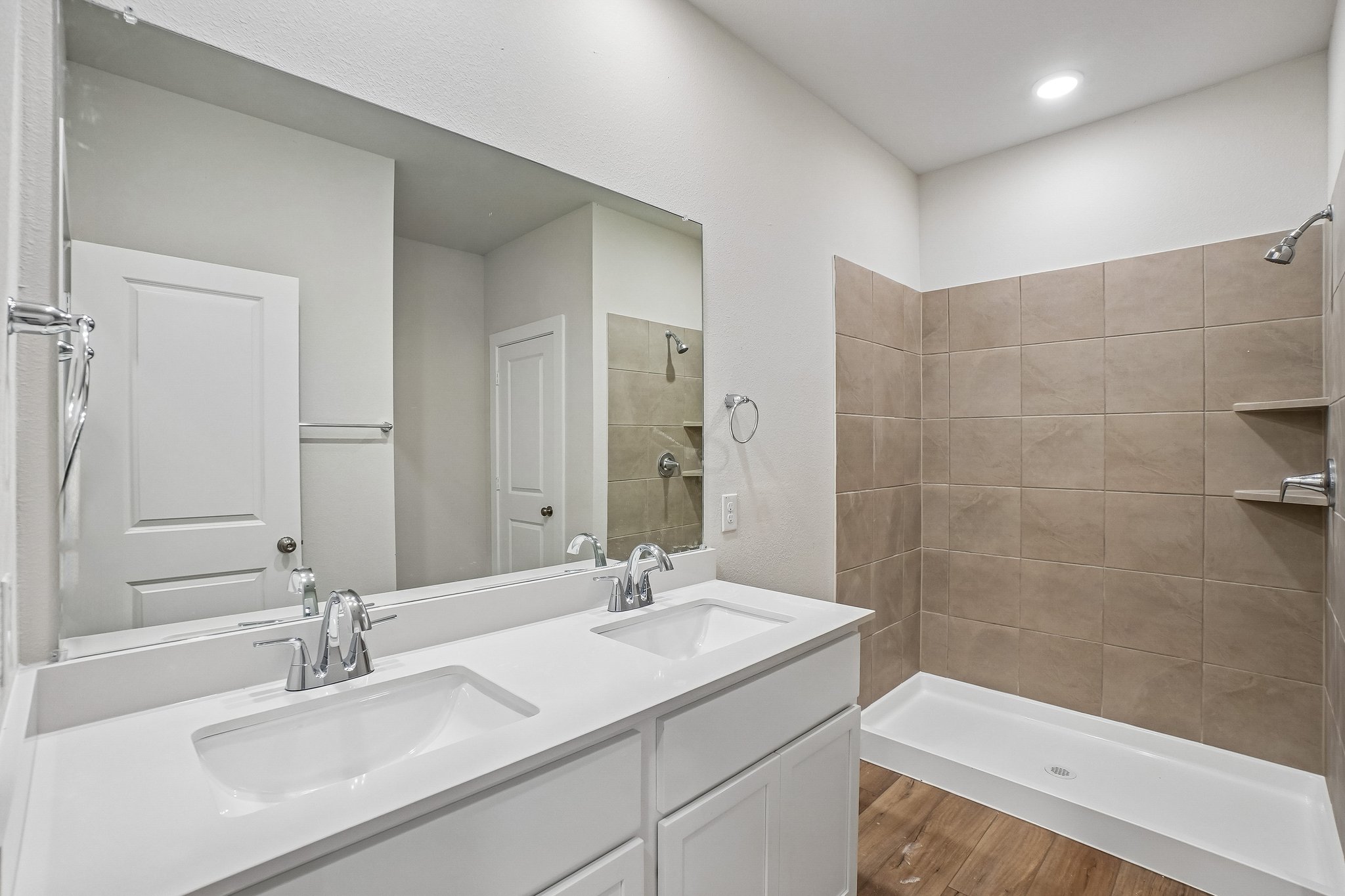A bathroom with a large mirror.