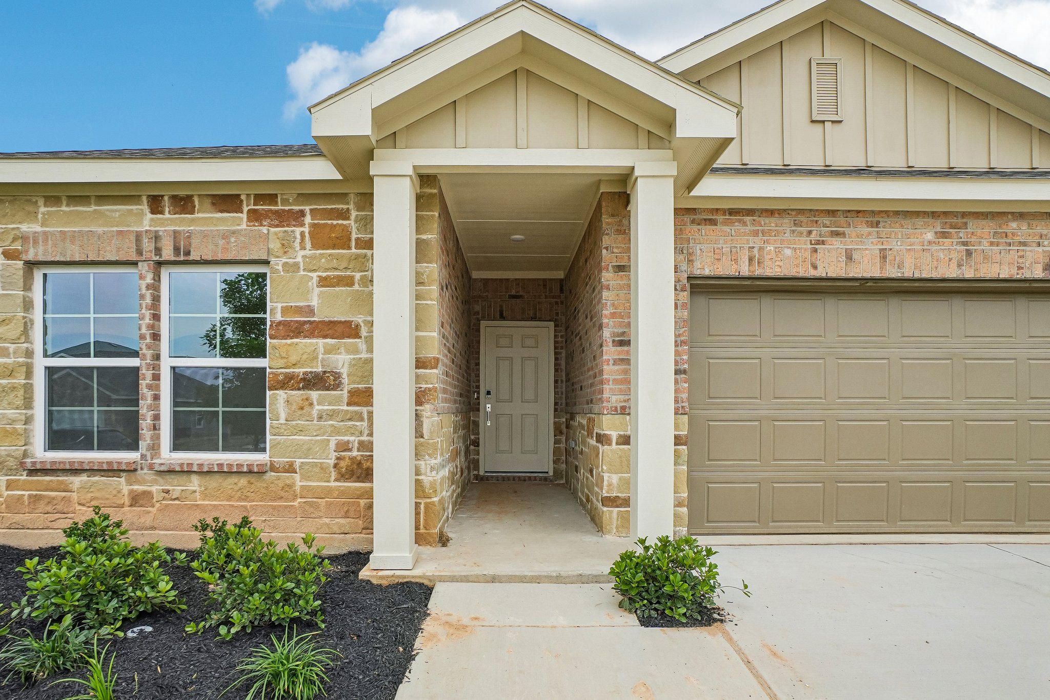 A house with a garage and a door.