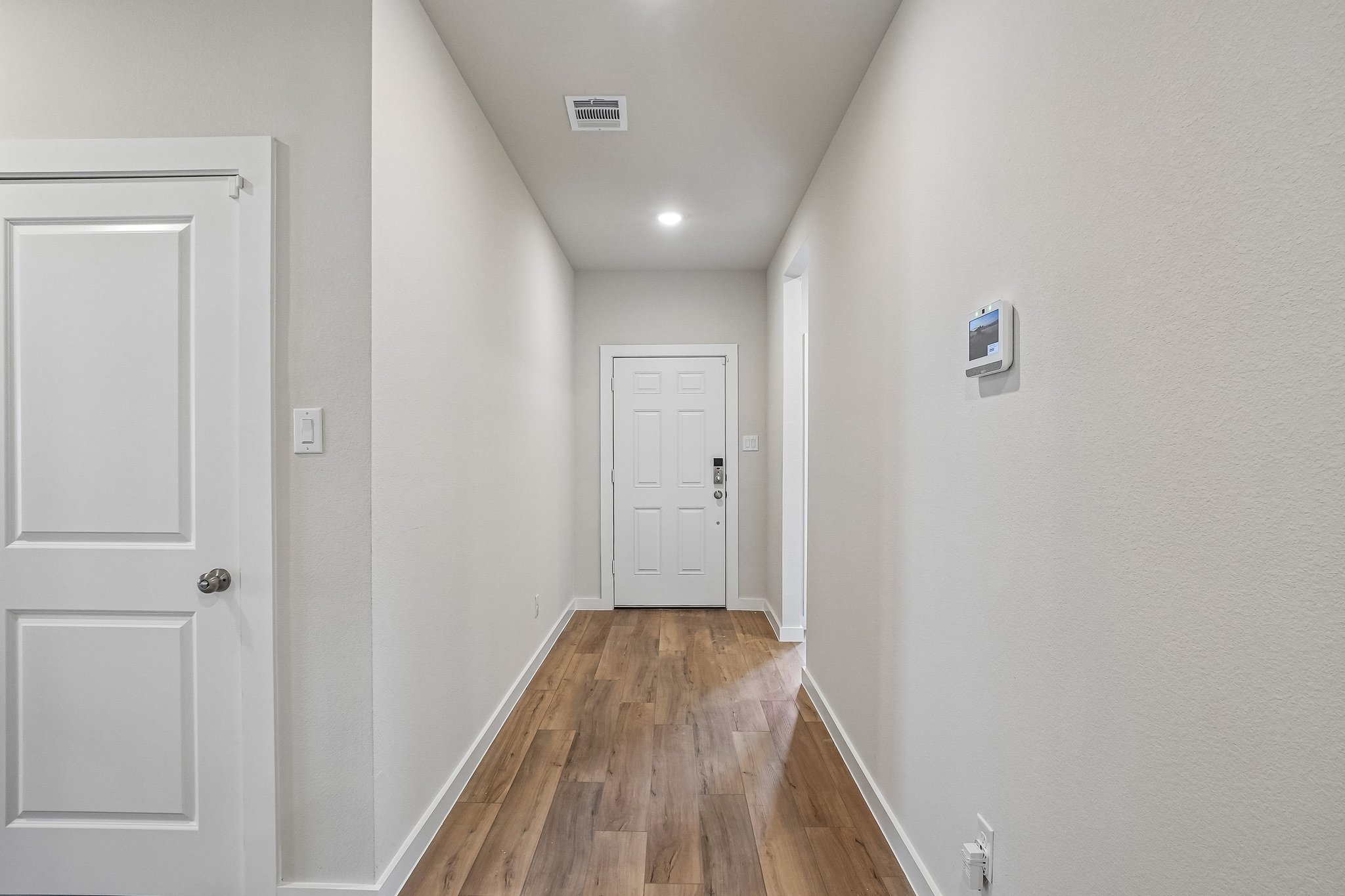 A hallway with white doors.