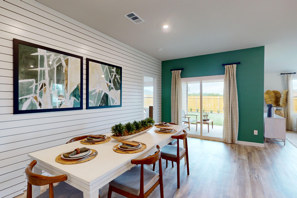 A dining room with a table set.