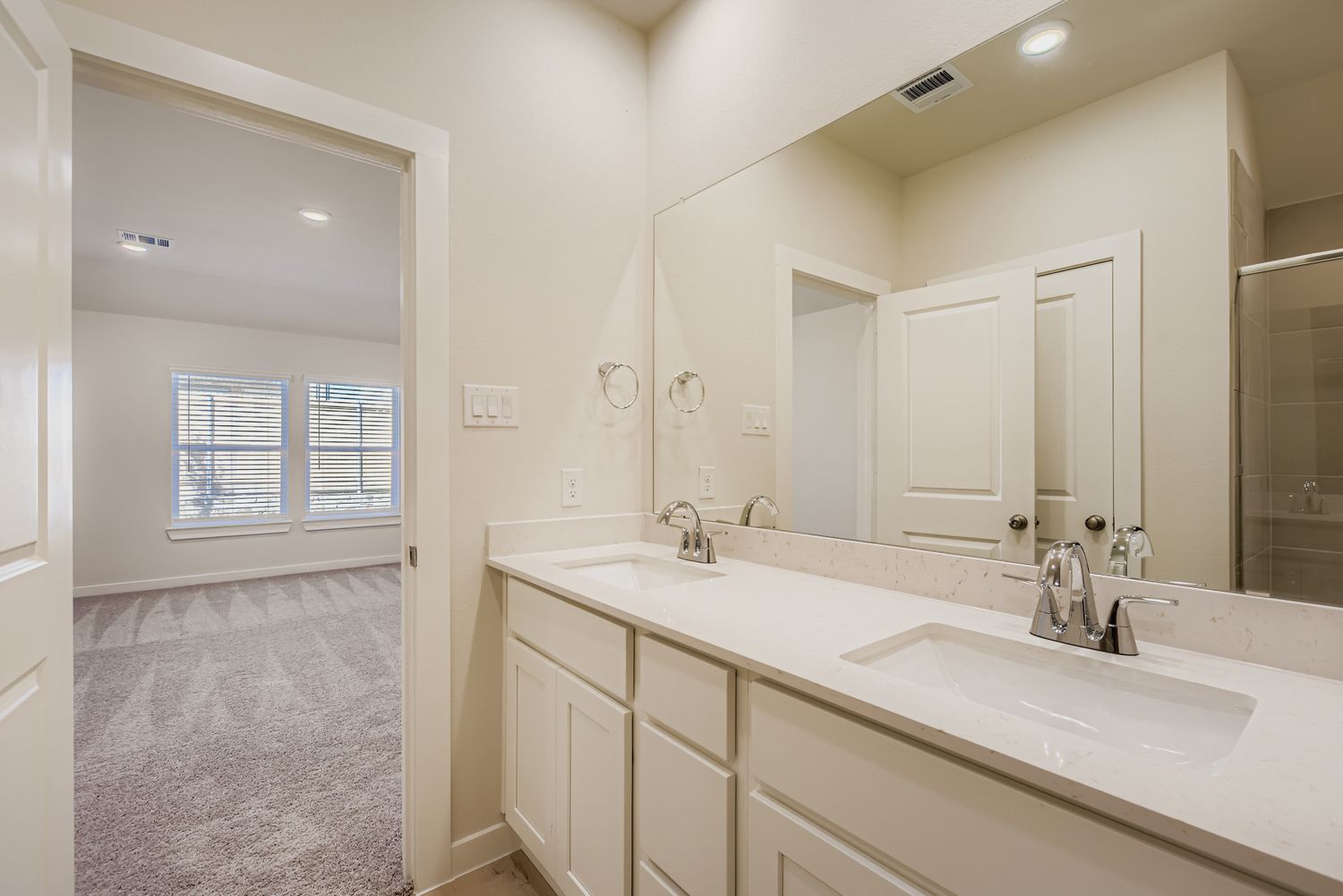 A bathroom with a large mirror.