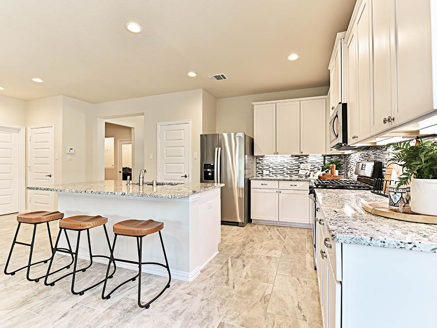 A kitchen with stools and a bar stool.