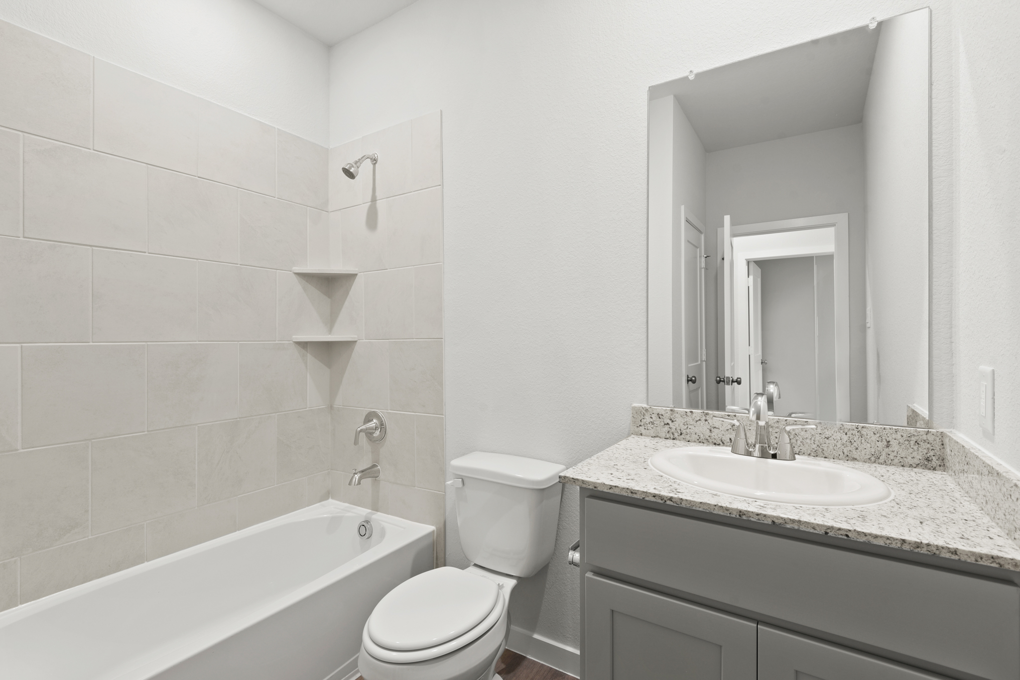 A bathroom with a tub sink and toilet.
