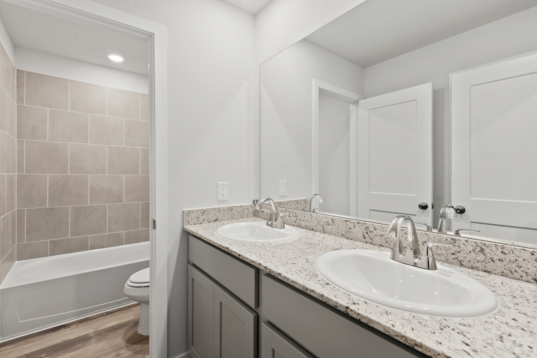 A bathroom with a large mirror.