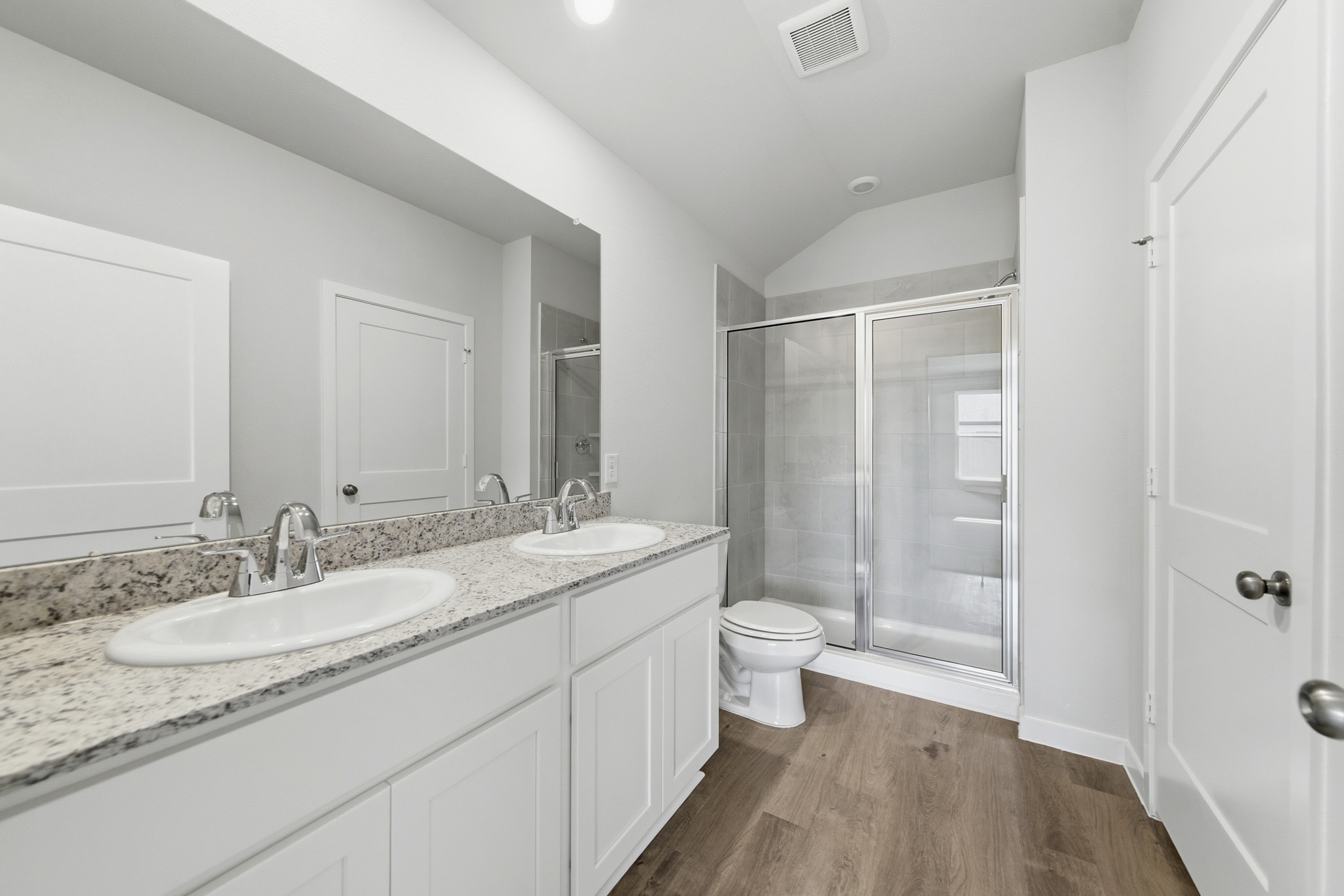 A bathroom with a sink toilet and shower.