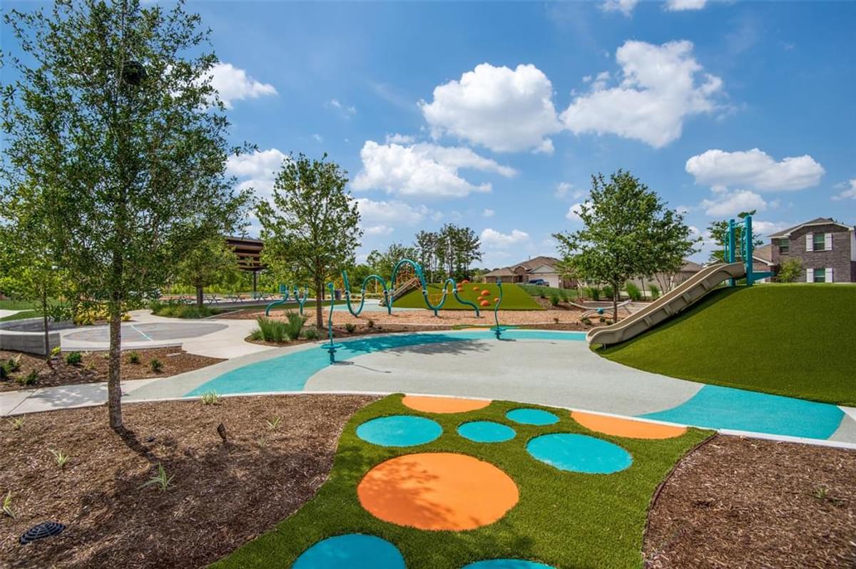 A large green park with a swimming pool.