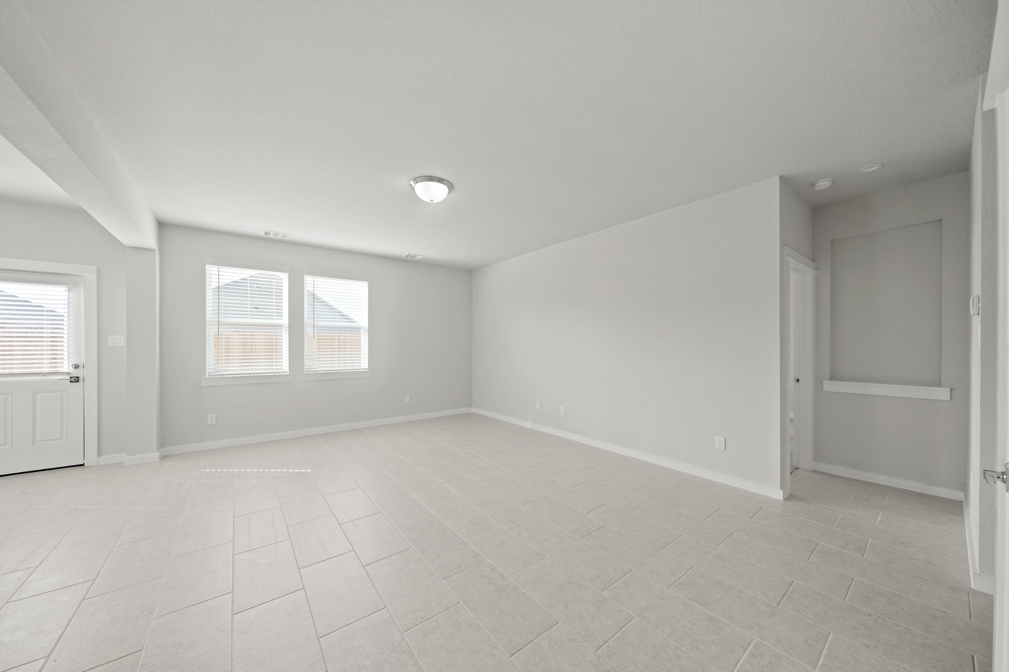 A room with white walls and windows.
