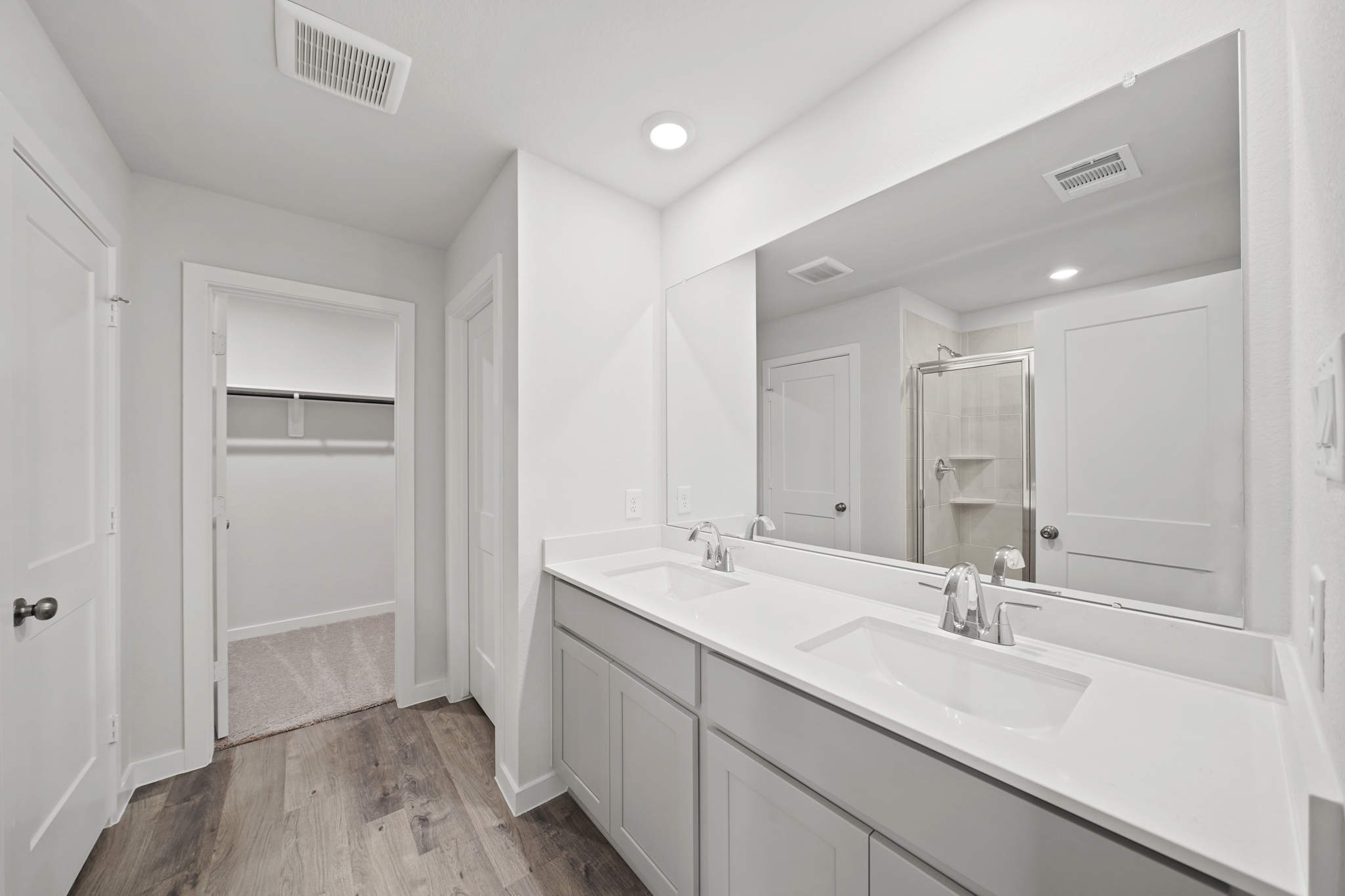 A bathroom with a tub sink and a mirror.