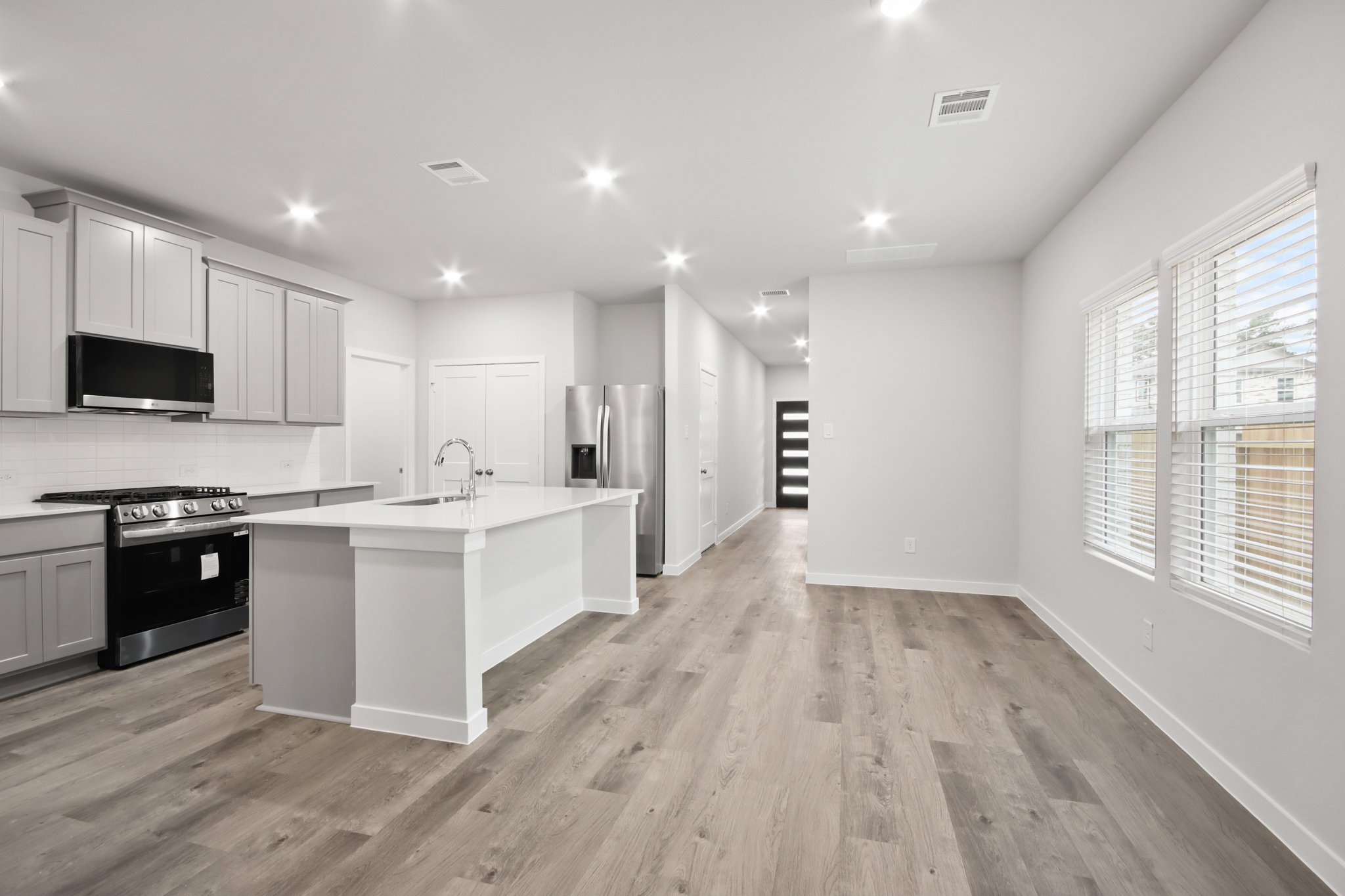 A kitchen with white cabinets.
