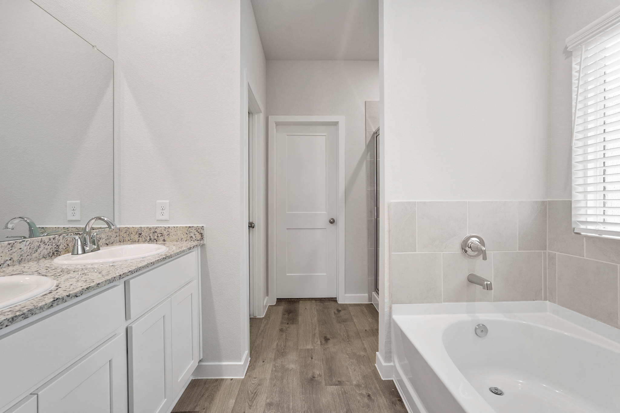 A bathroom with a tub sink and a bathtub.