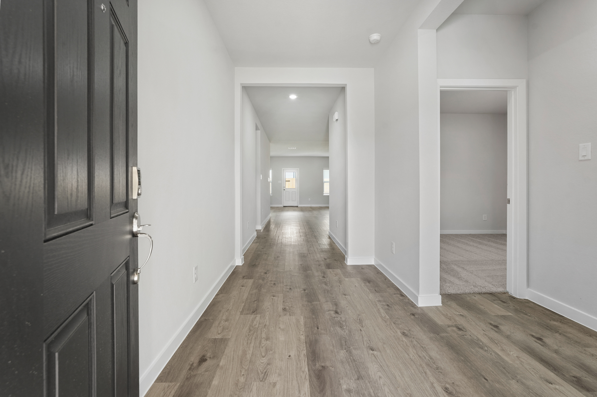 A hallway with white walls.