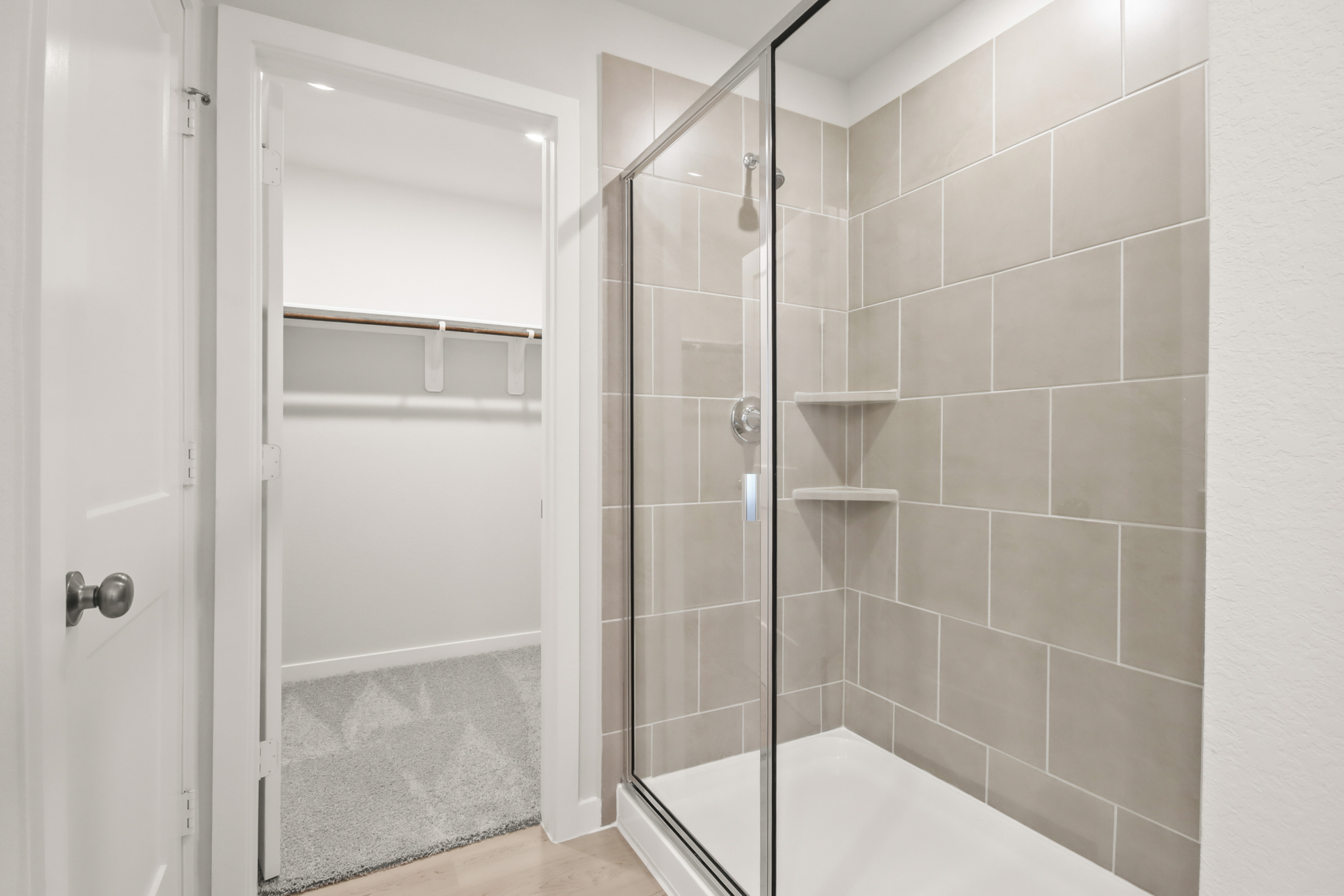 A shower with a glass door.