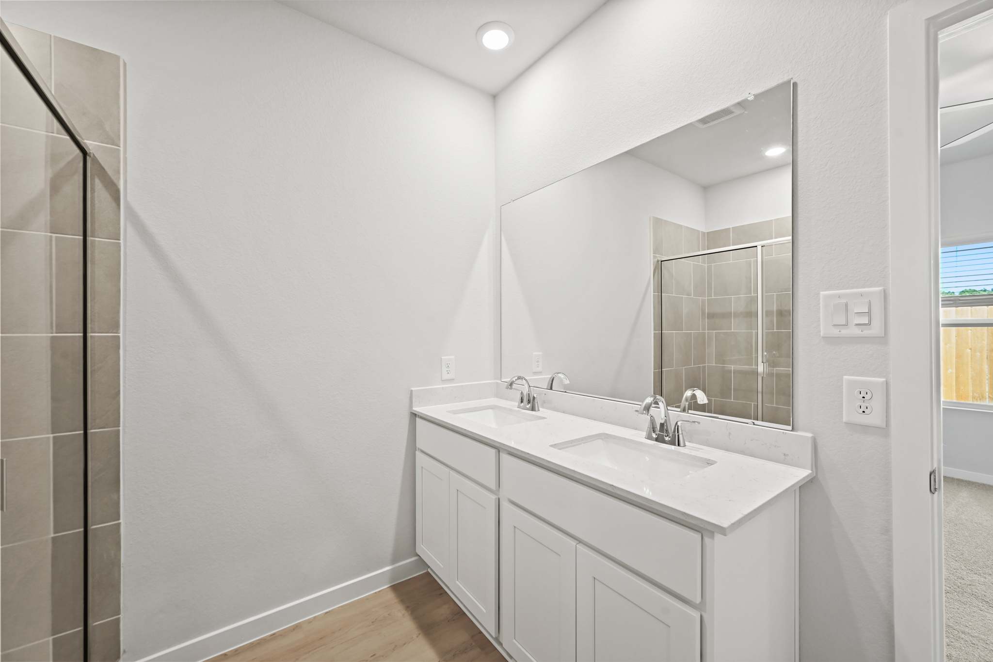A bathroom with a large mirror.