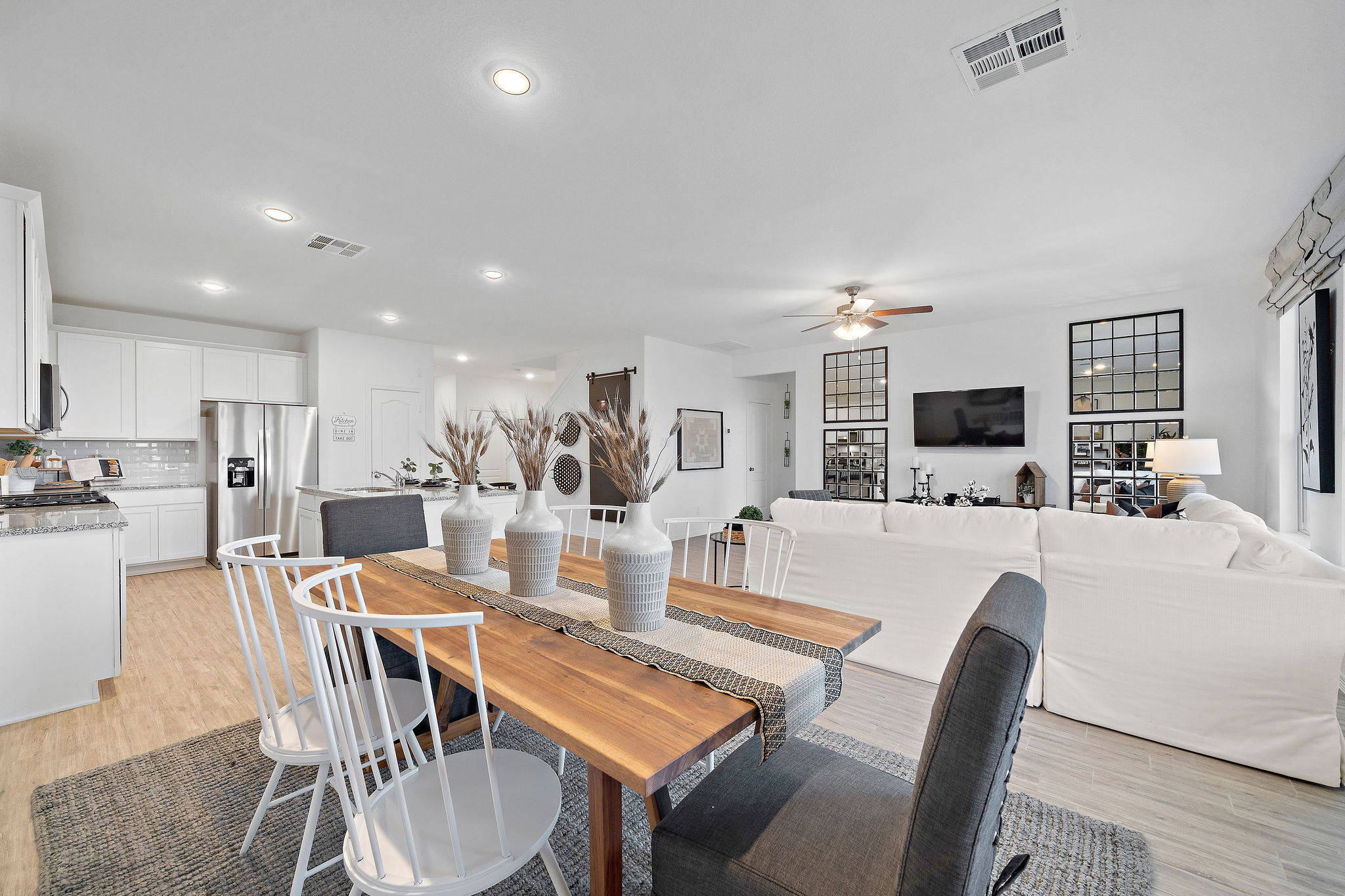 A large living room with a dining table and couches.