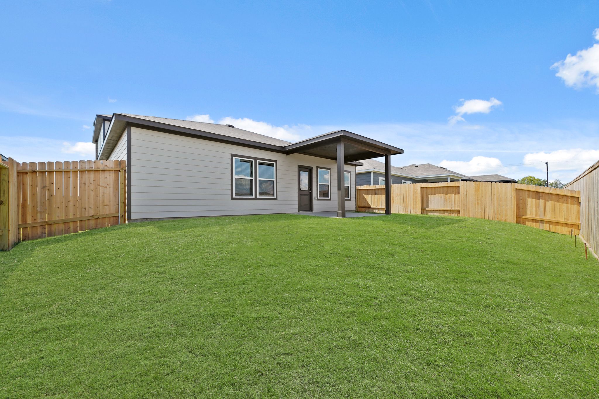 A house with a green lawn.