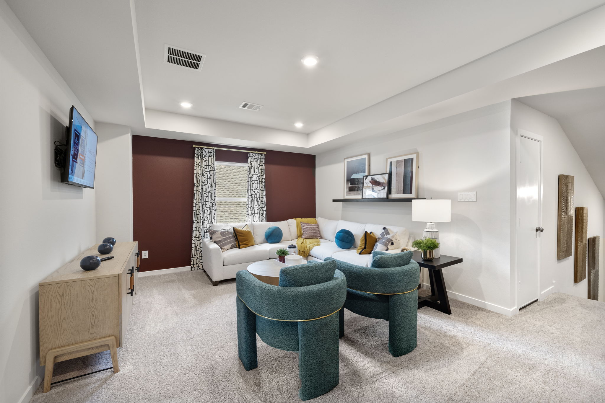 A living room with a couch and chairs.