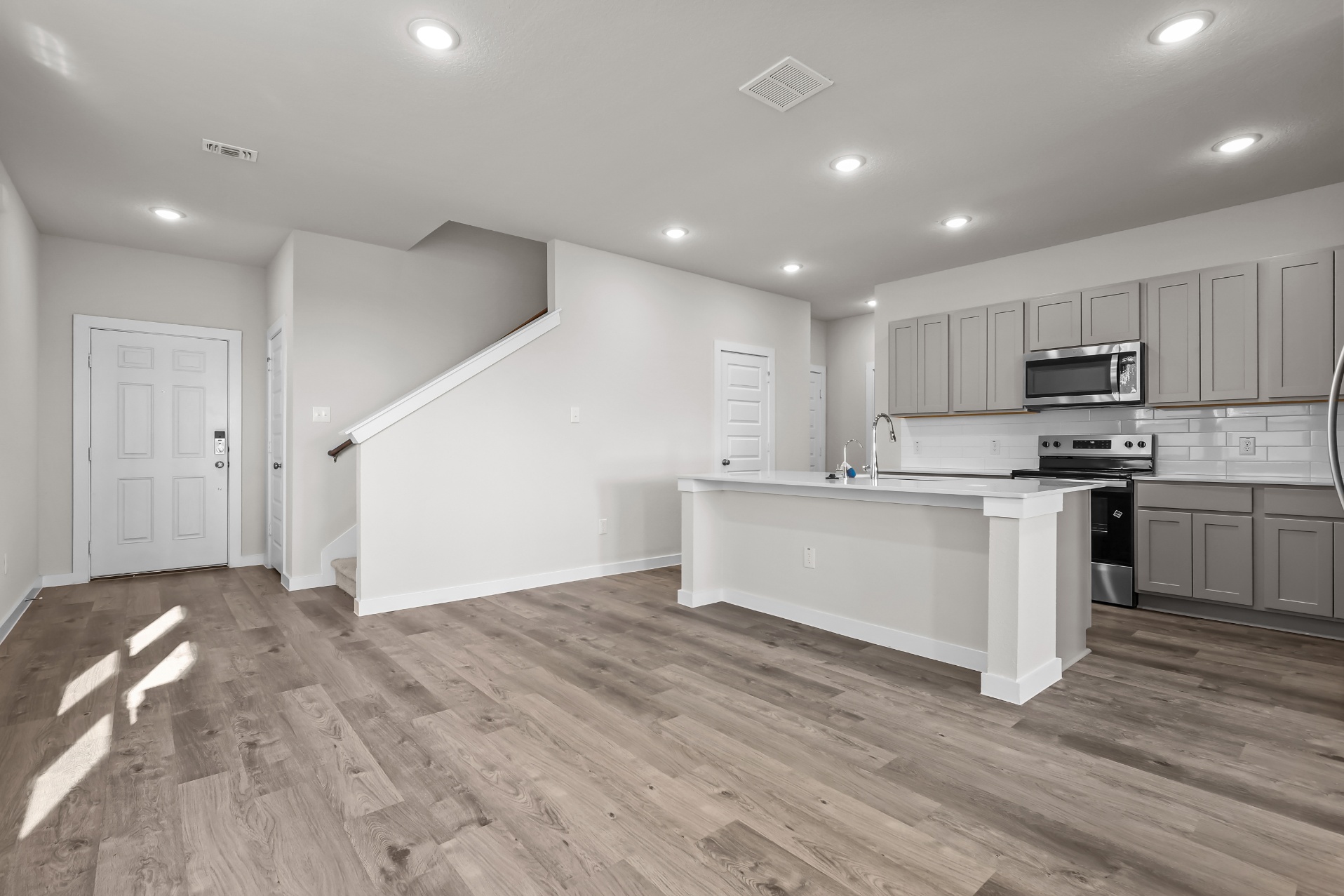 A kitchen with white cabinets.