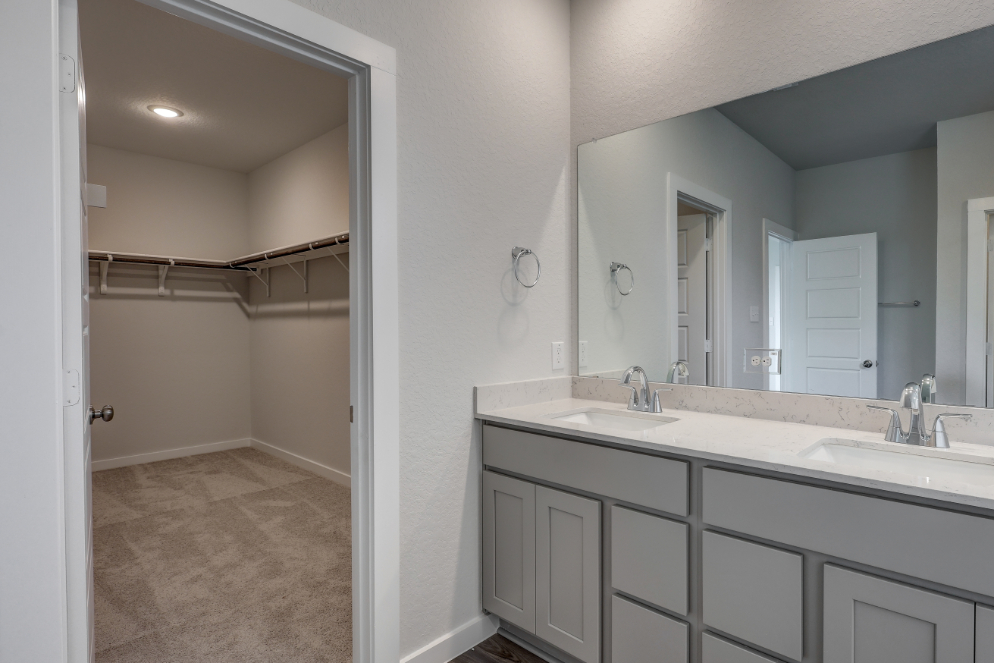 A bathroom with a large mirror.