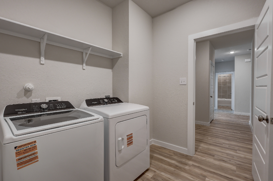 A kitchen with a washer and dryer.