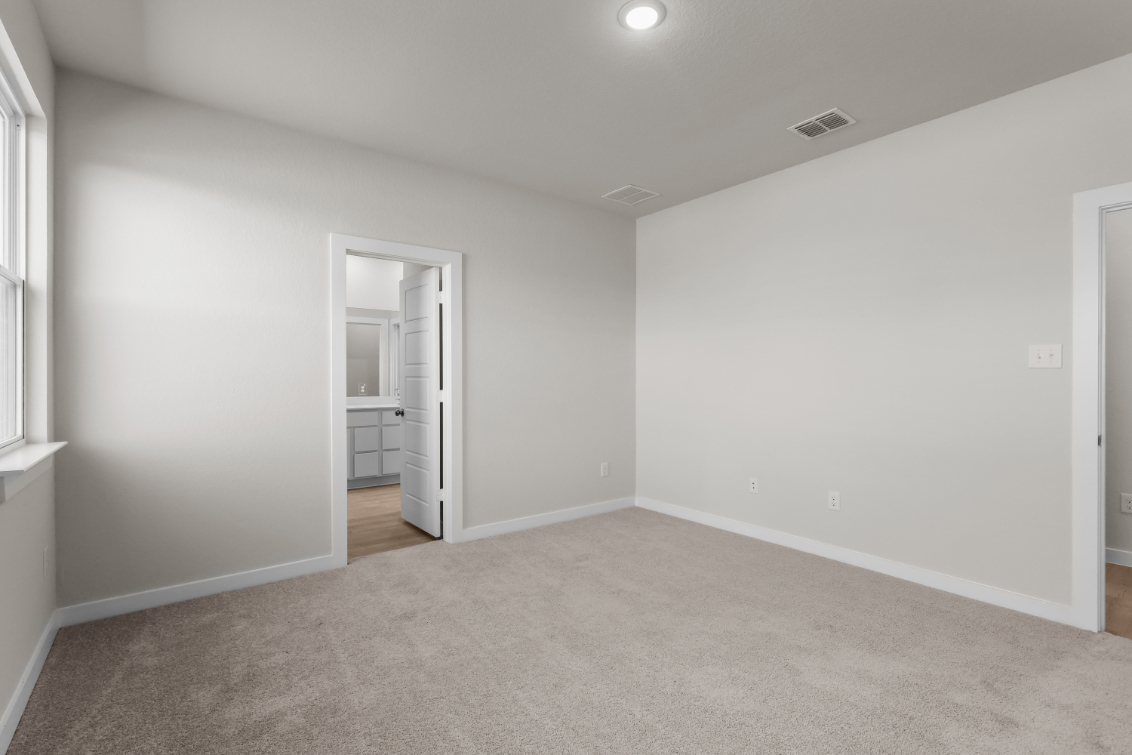 A room with a door and a mirror.