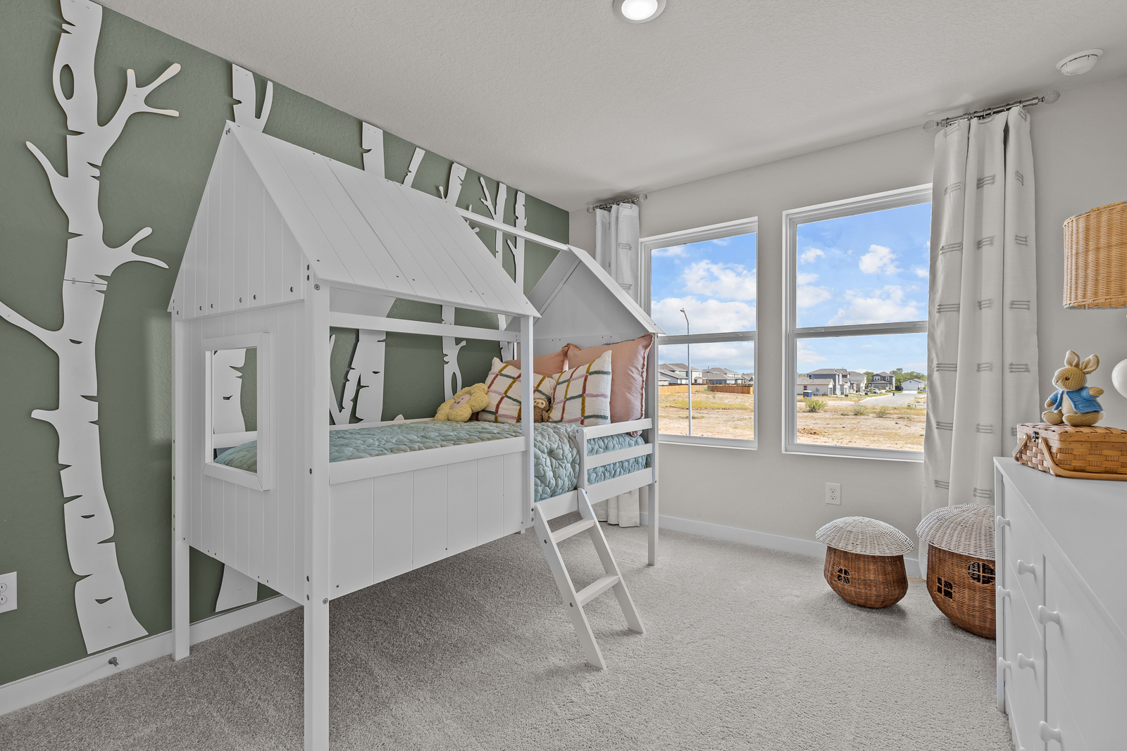 A room with a bed and a window with a view of the water.