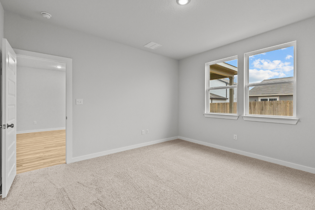 A room with a window and a door.