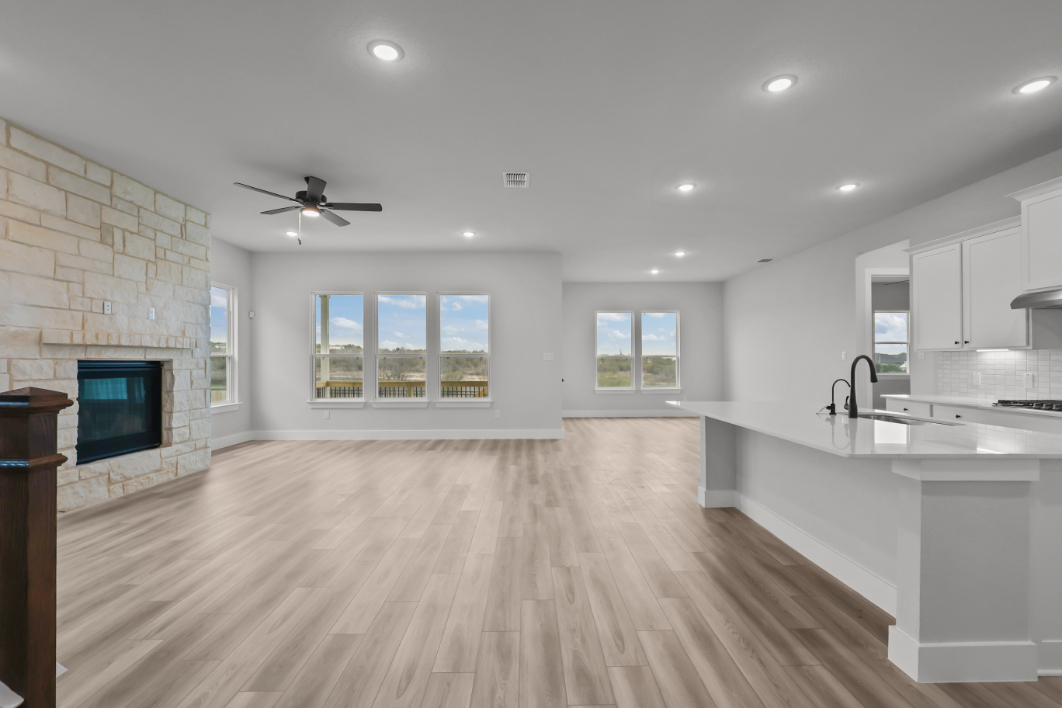 A large kitchen with a wood floor.