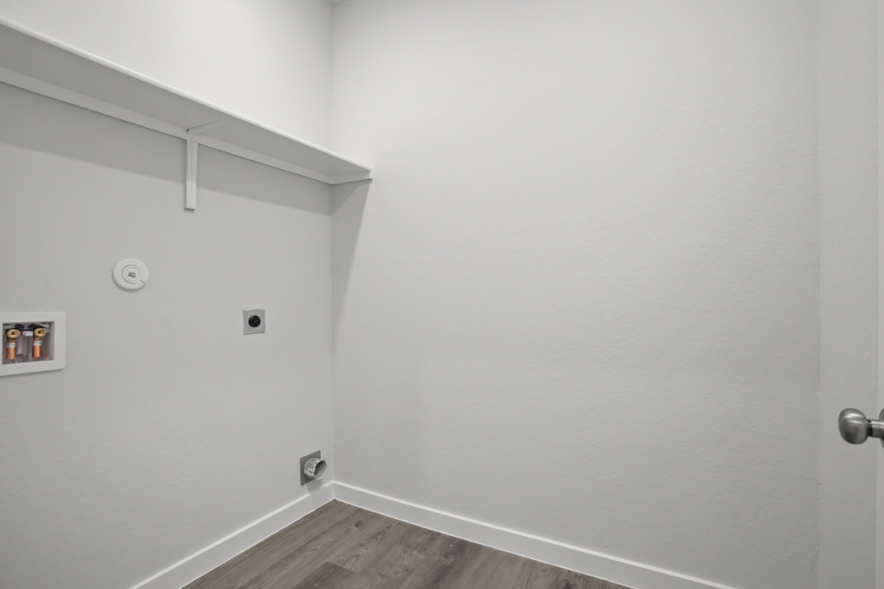 A white wall with a light on it.