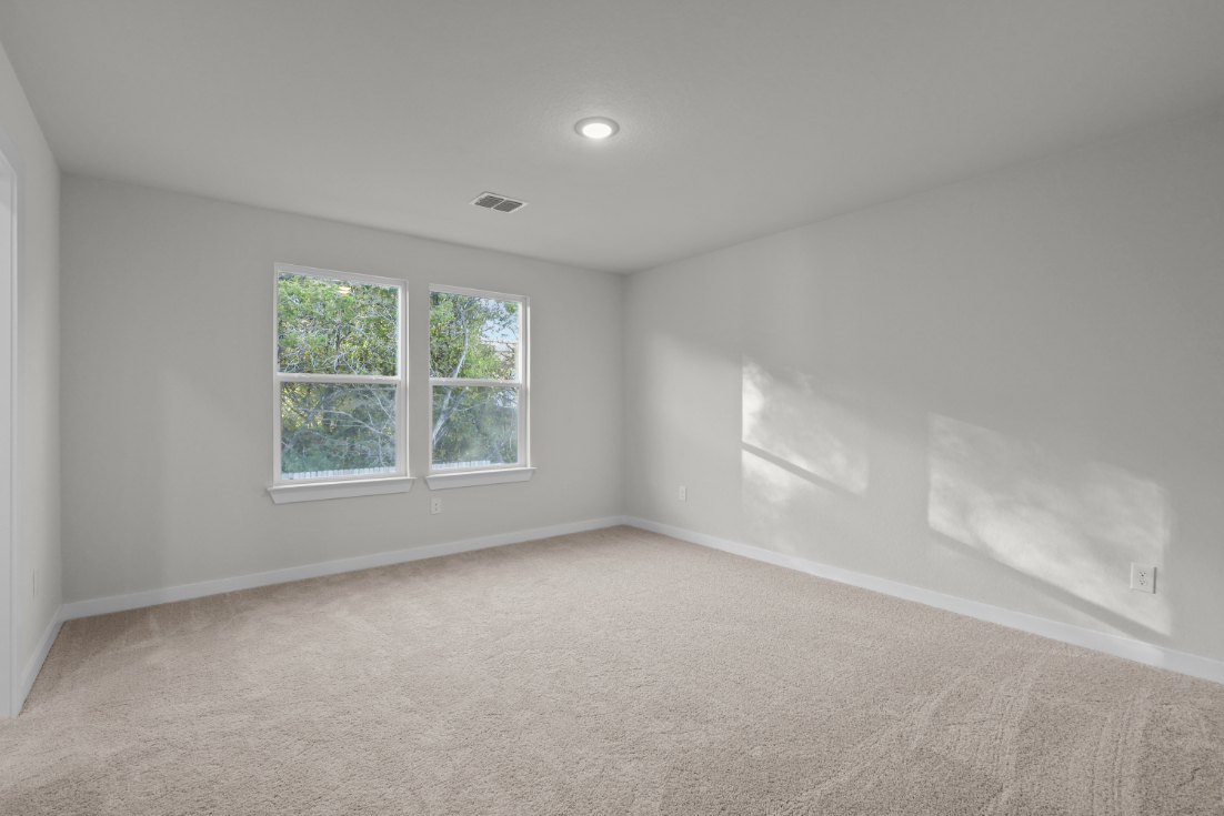 A room with a window and a carpet.