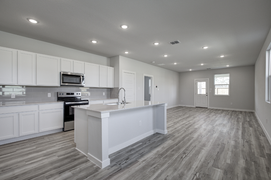 A kitchen with white cabinets.