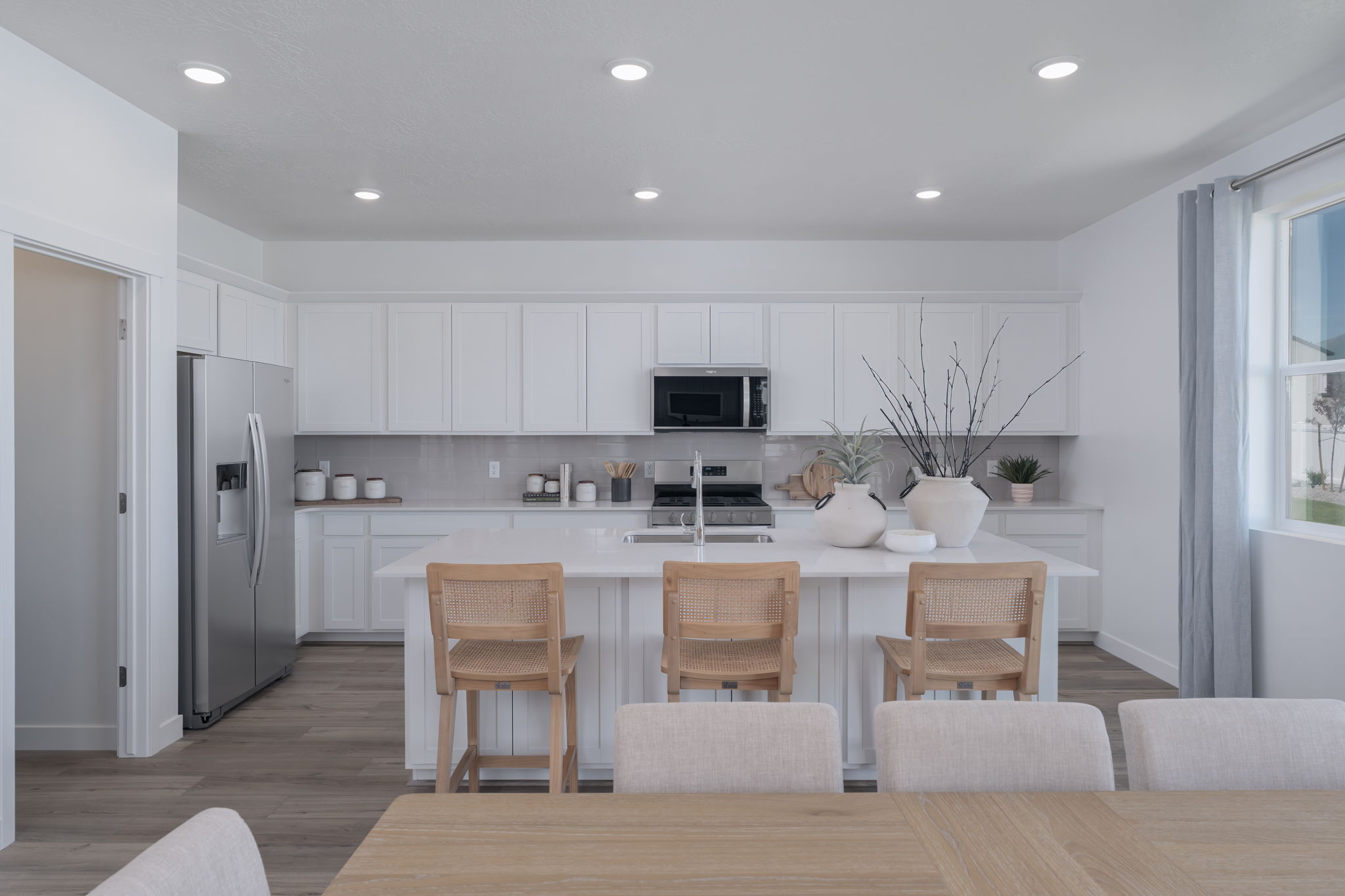 A kitchen with white cabinets.