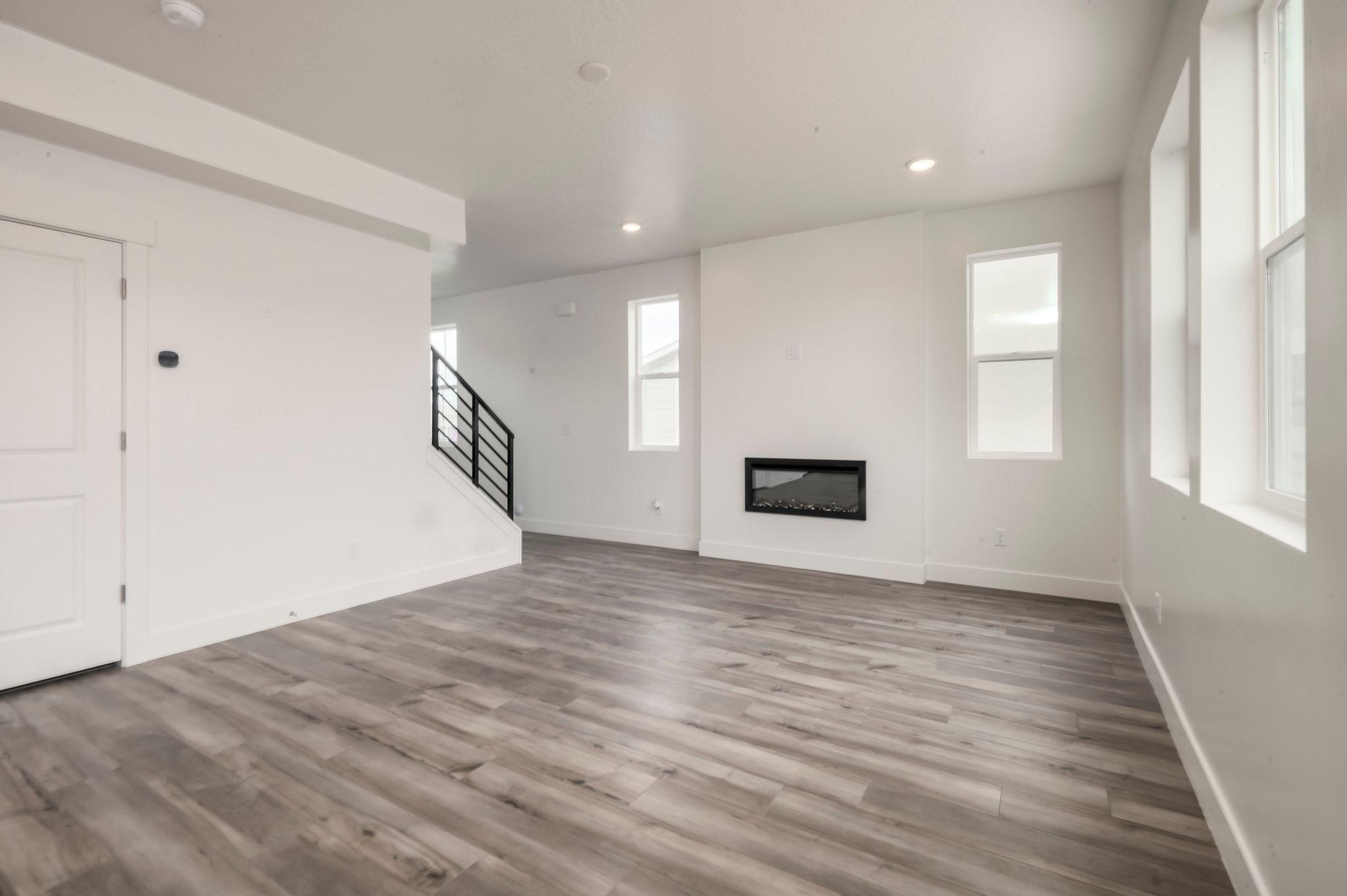 A room with a wood floor and white walls.