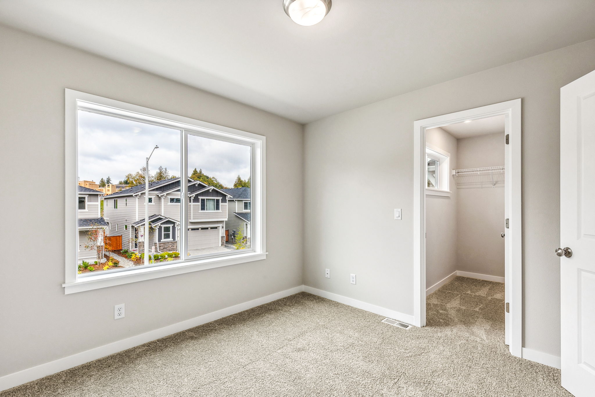 A room with a window and a door.