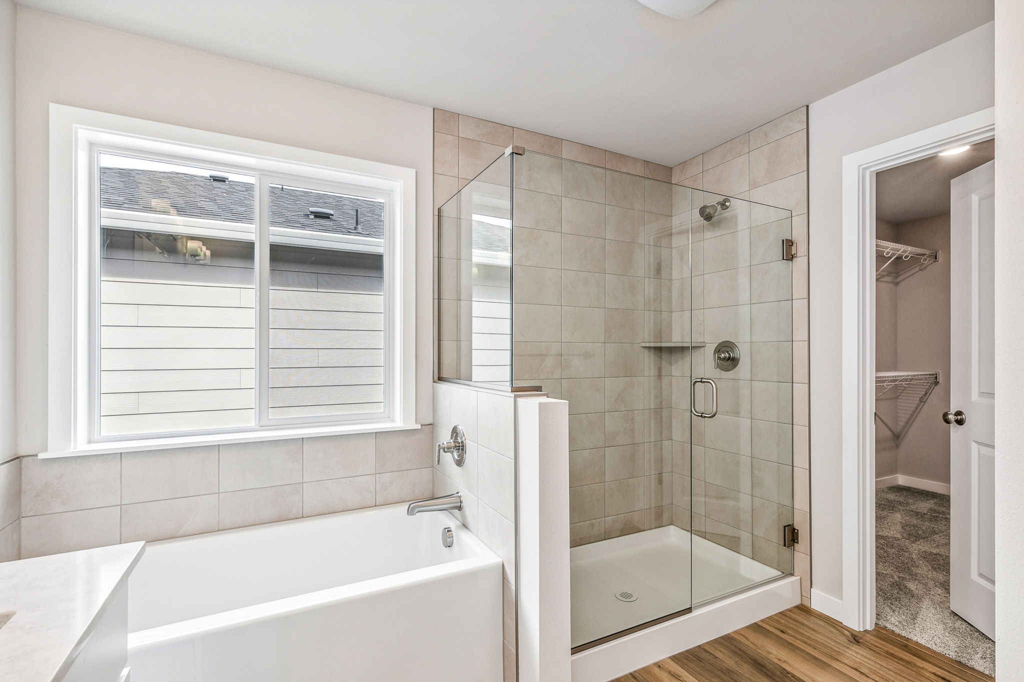 A bathroom with a tub and shower.